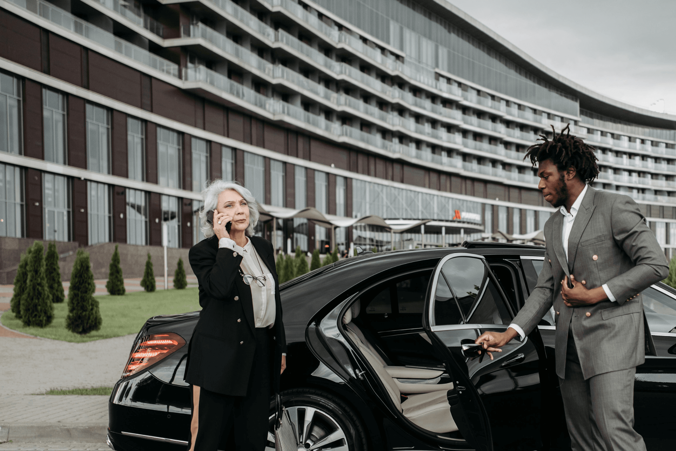 A BlackDrivo chauffeur welcoming a passenger